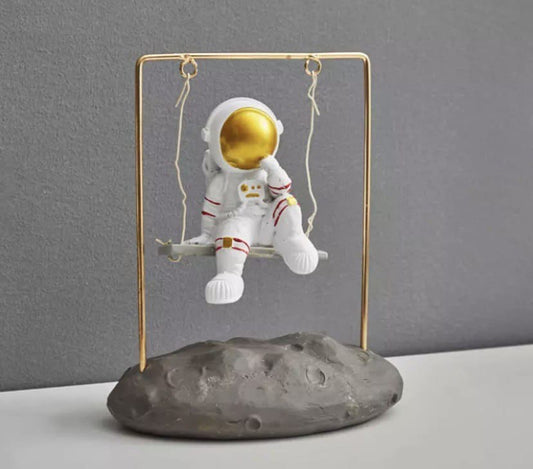 Astronaut figurine on a swing