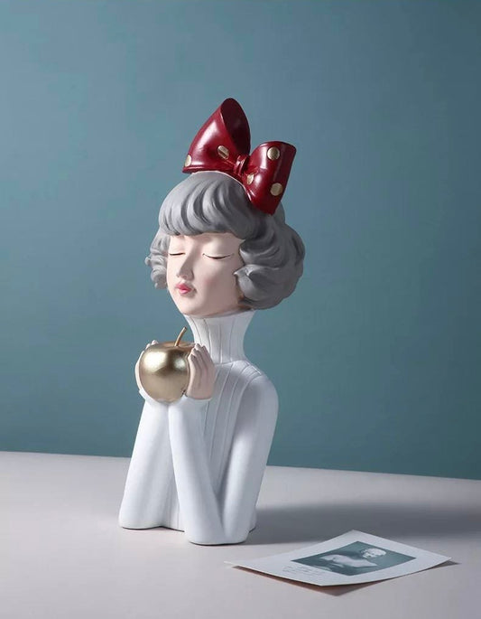Figurine of a girl with an apple