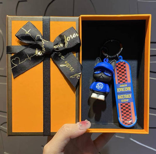 Keychain dog with skateboard blue