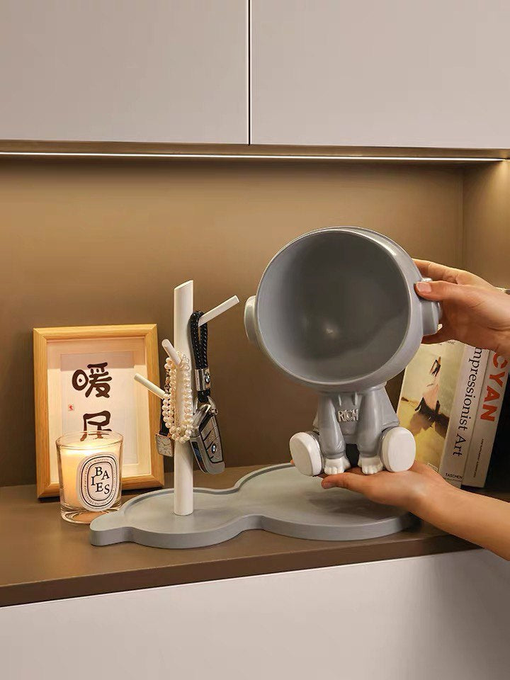 Astronaut figurine with a stand for small items, gray