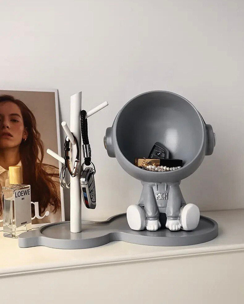 Astronaut figurine with a stand for small items, gray