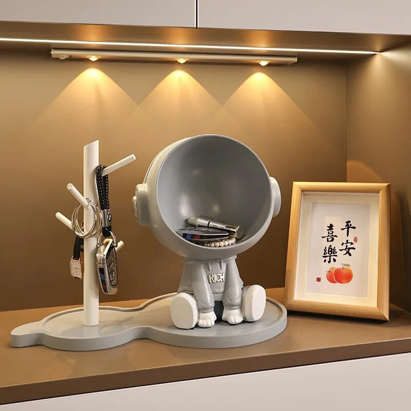 Astronaut figurine with a stand for small items, gray