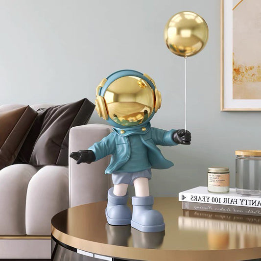 Blue astronaut figurine with ball