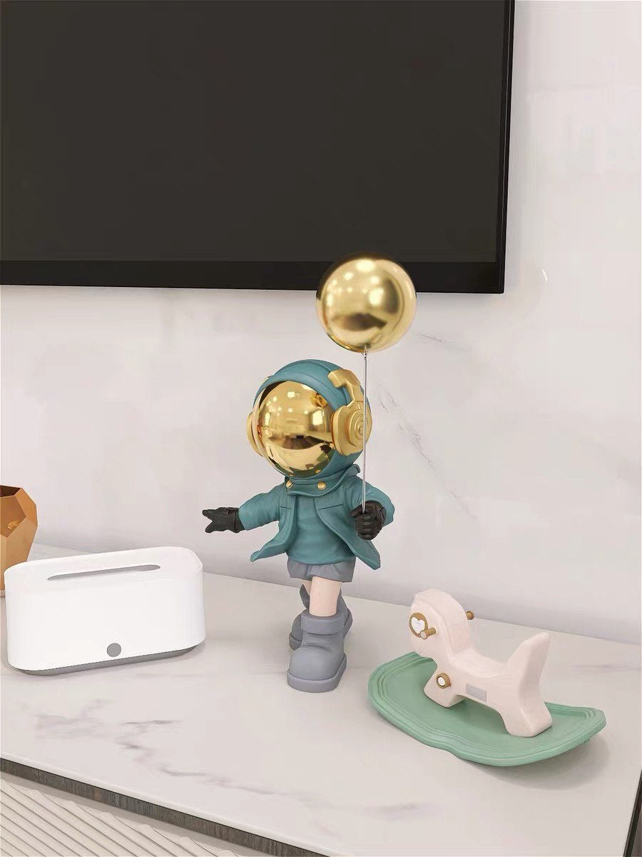Blue astronaut figurine with ball