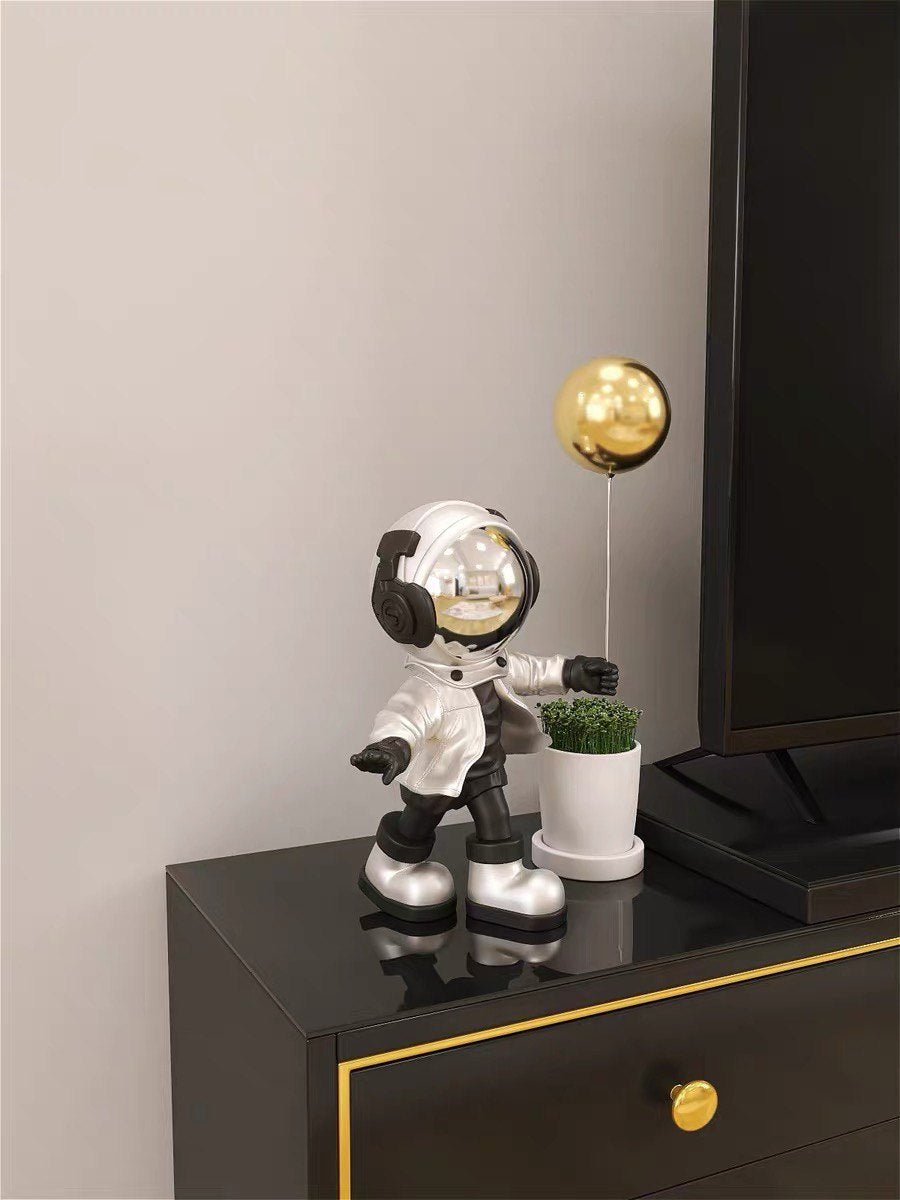 Silver astronaut figurine with ball