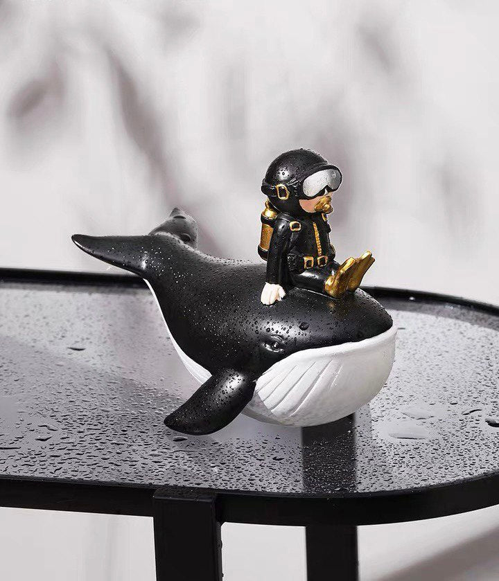 Statuette of a diver on a whale