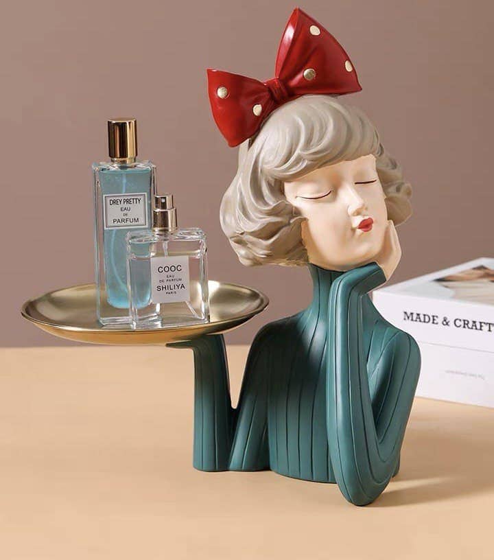 Decorative figurine girl with a tray