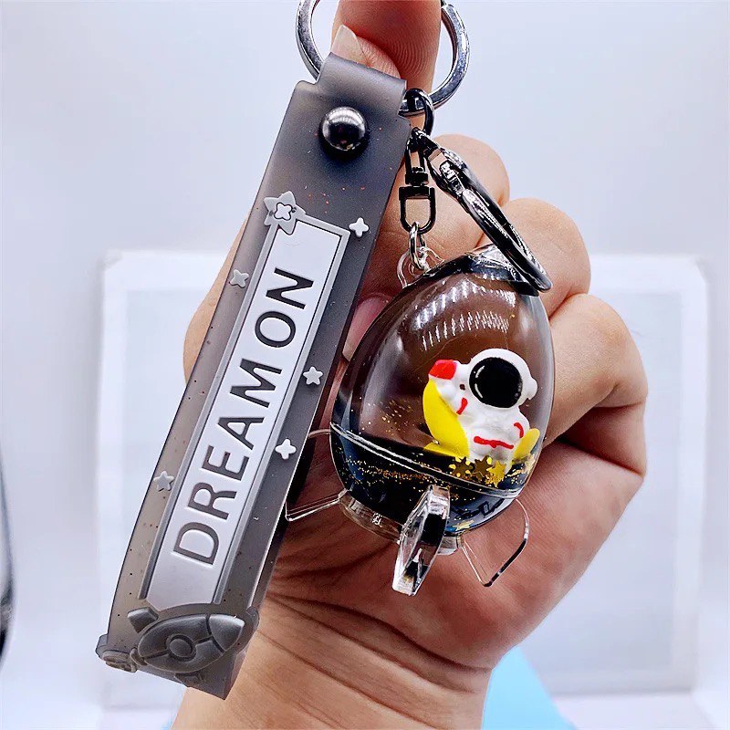 Keychain astronaut in a rocket on moon