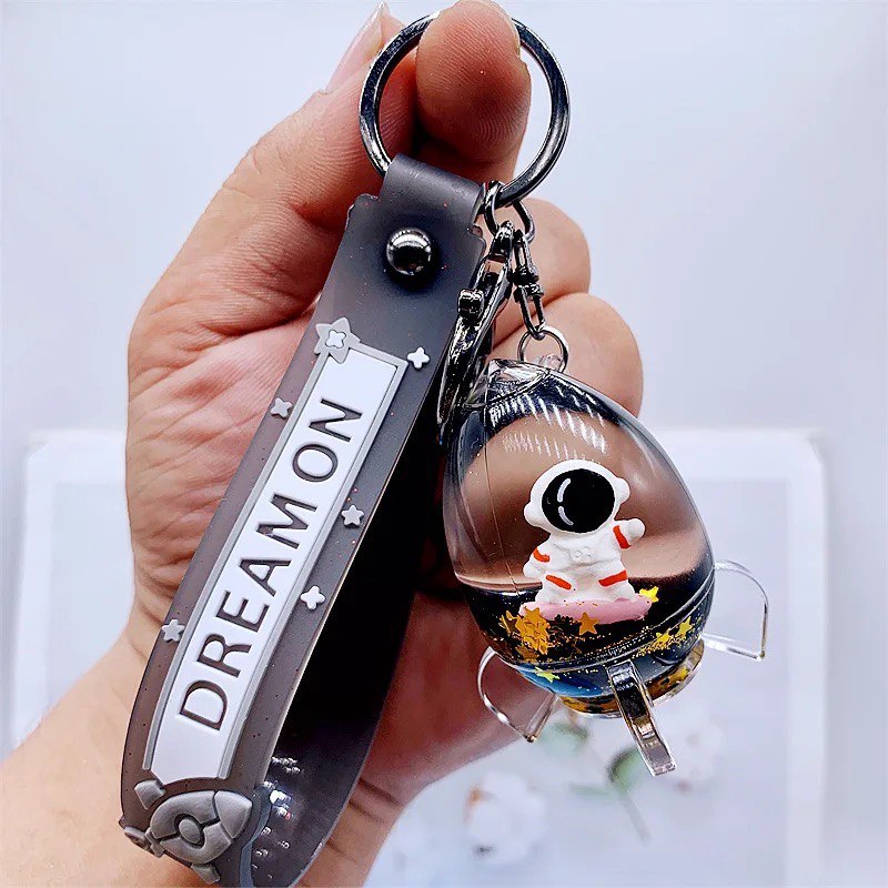 Keychain astronaut in a rocket on skateboard