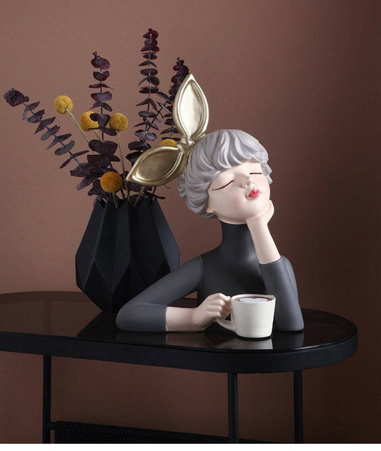 Figurine of a girl with a cup of coffee