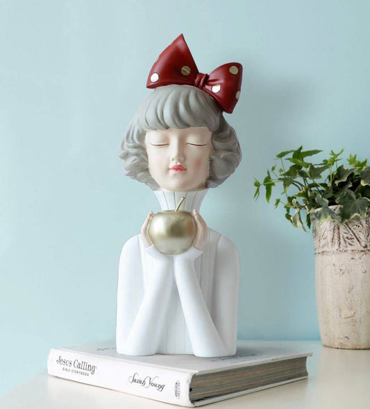 Figurine of a girl with an apple