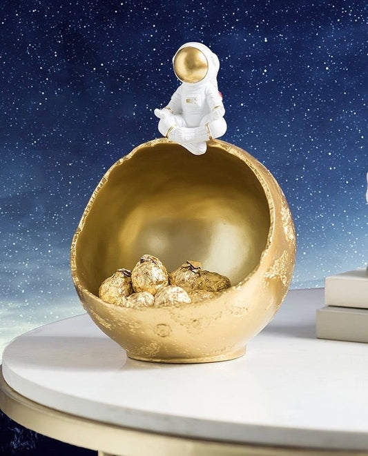 Figurine, candy container astronaut on the moon meditating