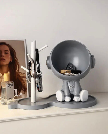 Astronaut figurine with a stand for small items, gray