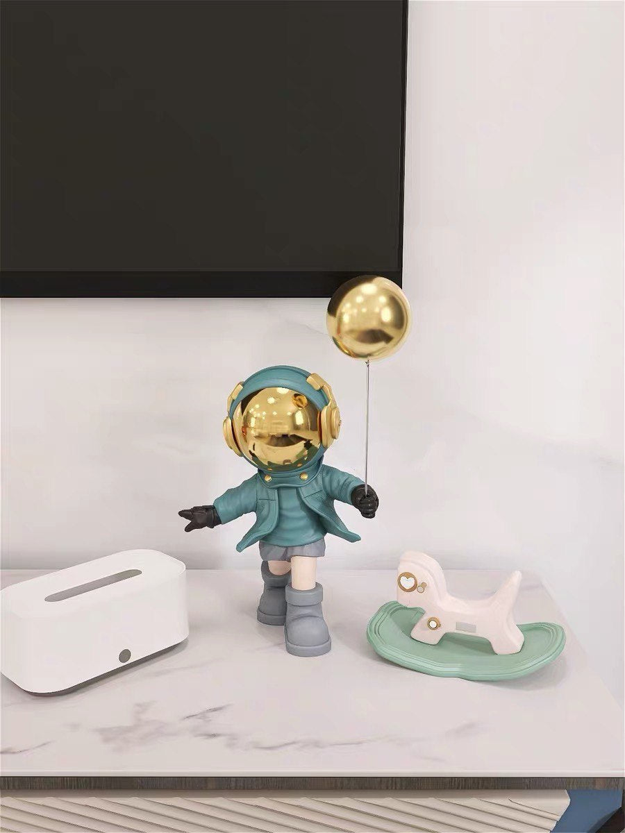 Blue astronaut figurine with ball