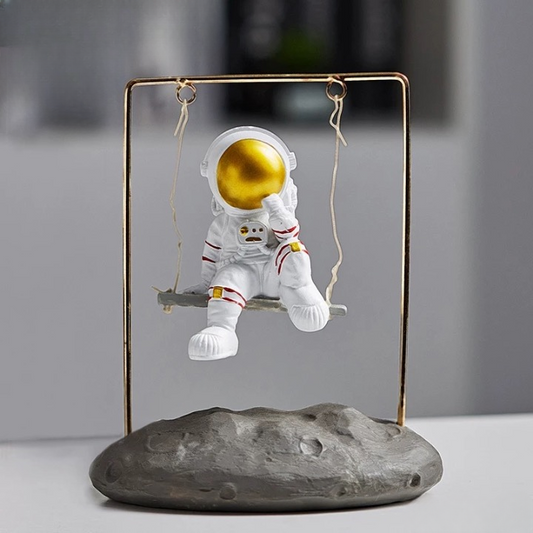 Astronaut figurine on a swing