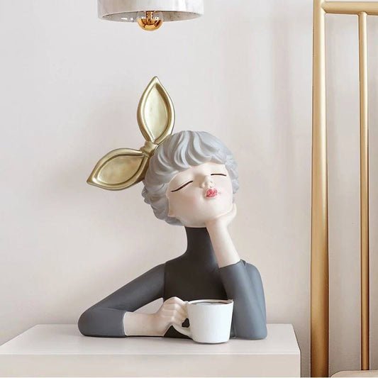 Figurine of a girl with a cup of coffee
