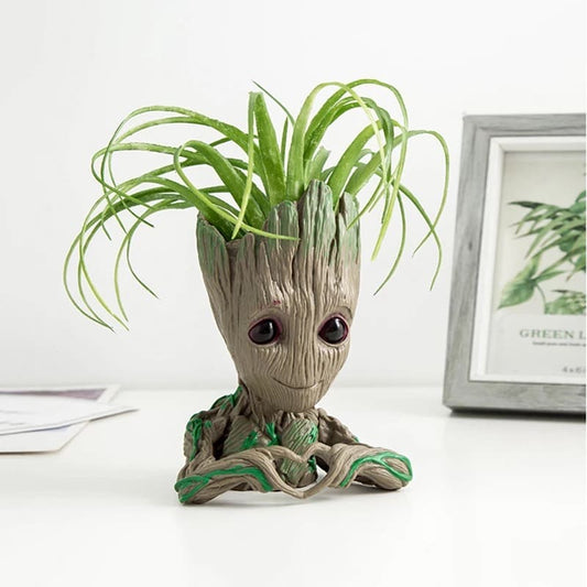Vase, plant pot, plant heart in hands