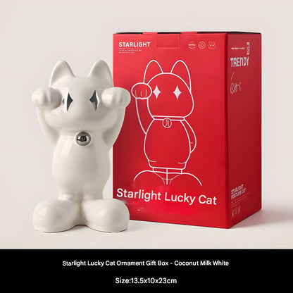A coconut milk white ceramic Starlight Lucky Cat ornament standing next to its red gift box, with a black text bar at the bottom containing product details.