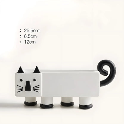 A white cat-shaped planter with black accents, including pointed ears, facial features, whiskers, and a curled tail, shown on a plain light background with height measurements listed on the left.