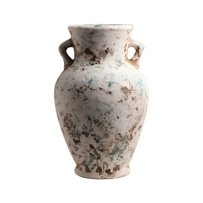 An ancient-style ceramic vase with two side handles, featuring a distressed off-white glaze with mottled brown and teal patina details, isolated on a white background.