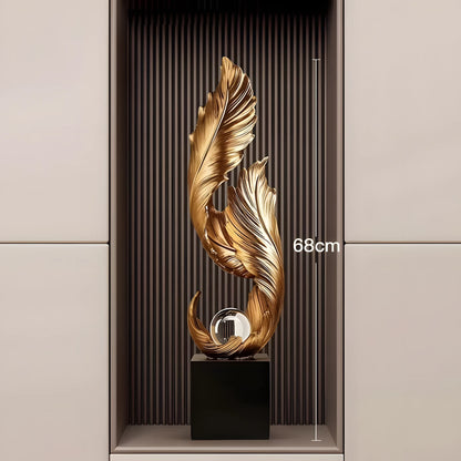 A decorative metallic gold leaf sculpture on a black pedestal, displayed in a recessed wall niche with a vertical dimension marker reading 68cm.