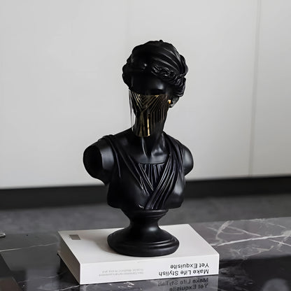 Black bust sculpture on a white platform with a neutral background