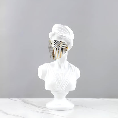 White bust wearing a white turban with a gold and black pattern on a gray background