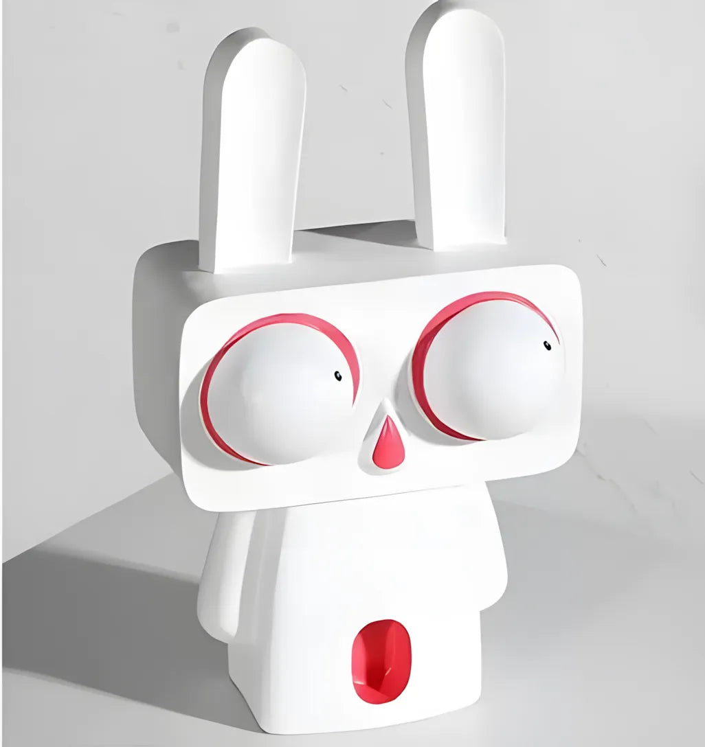 Angled view of the large white pop art rabbit figurine with big red-rimmed eyes standing on a clean white surface
