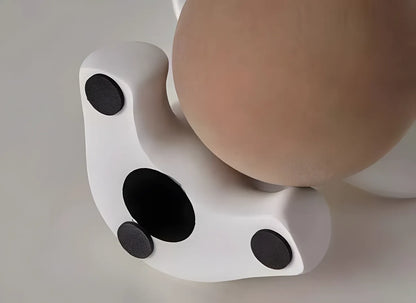Bottom view of the white elephant sculpture base showing three black non slip protective pads