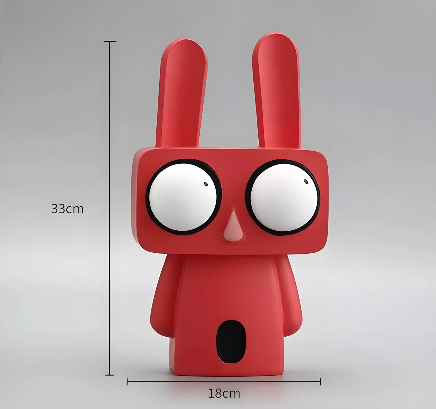 Coral red big-eyed rabbit art figurine standing on a black glass side table under a modern gold floor lamp in a living room