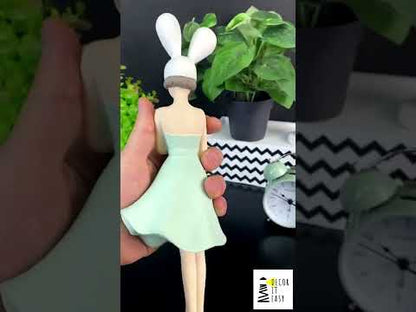 Figurine of a girl with rabbit ears