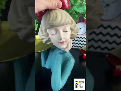 Decorative figurine girl with a tray