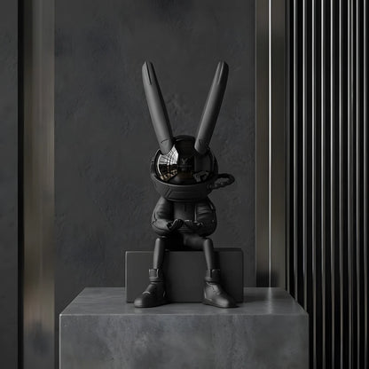 Front view of the 34cm sitting astronaut rabbit art figurine on a concrete pedestal block with a modern industrial background