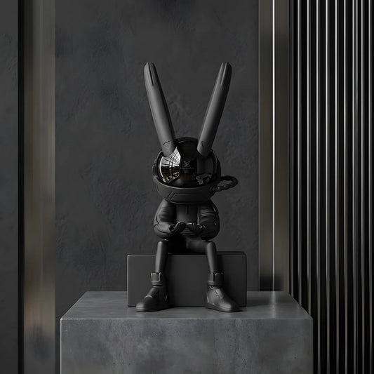 Front view of the 34cm sitting astronaut rabbit art figurine on a concrete pedestal block with a modern industrial background