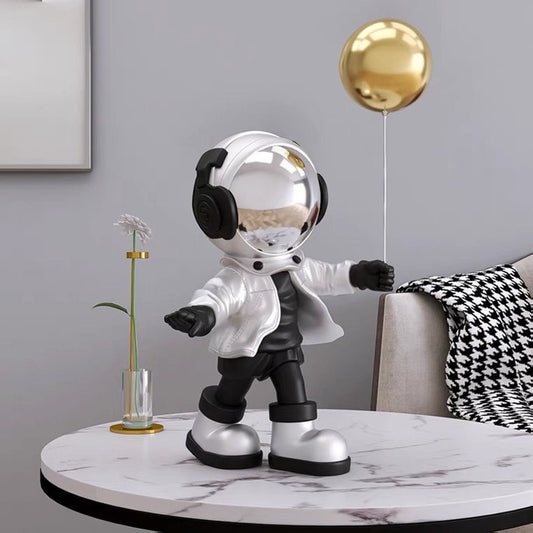 Silver astronaut figurine with ball