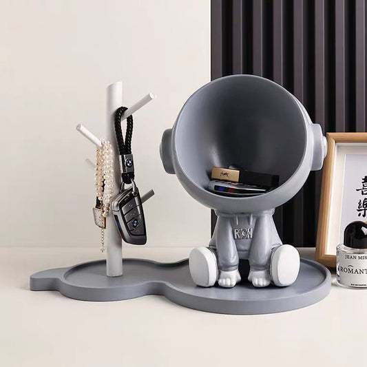 Astronaut figurine with a stand for small items, gray